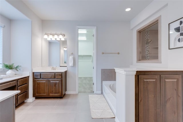 bathroom featuring a tub, tile patterned flooring, and vanity