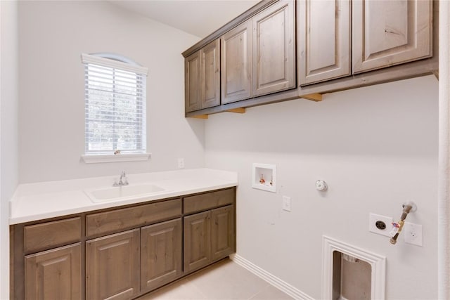 laundry room featuring sink, cabinets, electric dryer hookup, gas dryer hookup, and light tile patterned floors