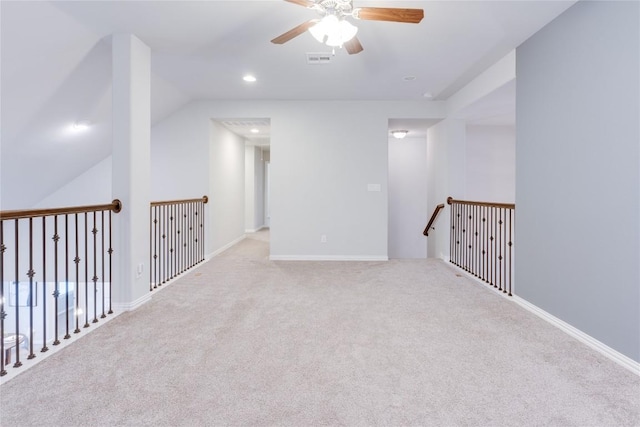 empty room with ceiling fan, light carpet, and lofted ceiling