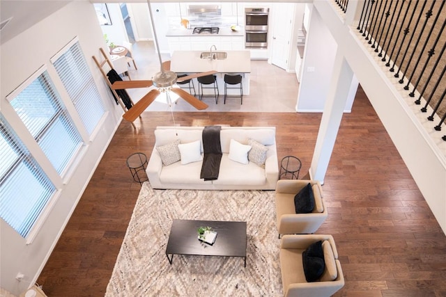 living room with hardwood / wood-style floors, plenty of natural light, and sink