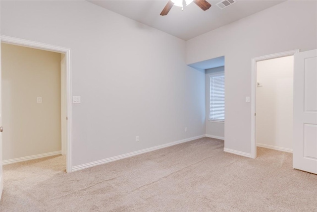 unfurnished bedroom featuring ceiling fan, light carpet, and a closet