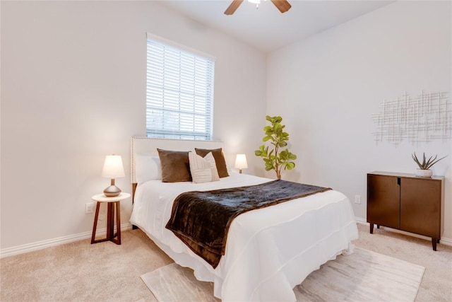 bedroom with ceiling fan and light carpet