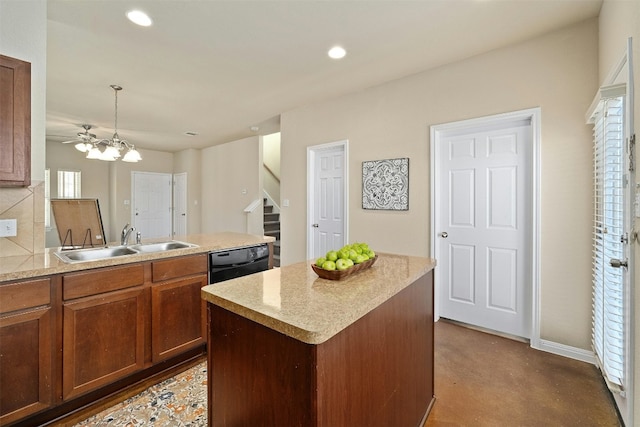 kitchen featuring pendant lighting, dishwasher, a center island, ceiling fan with notable chandelier, and sink