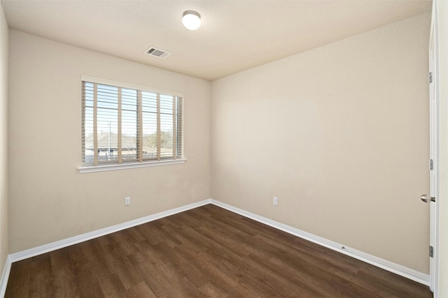 spare room with dark hardwood / wood-style floors