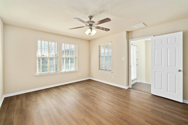 spare room with hardwood / wood-style flooring and ceiling fan