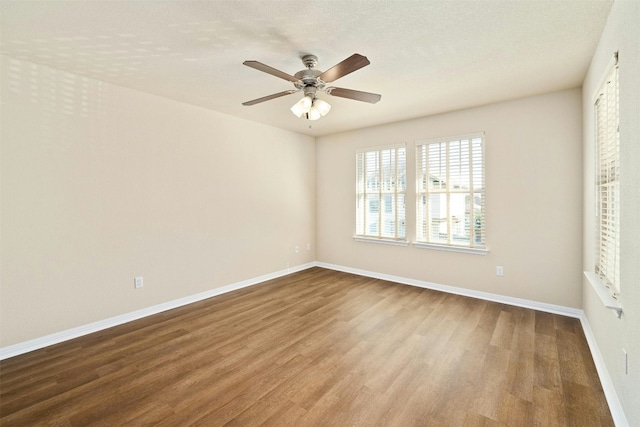 unfurnished bedroom with ceiling fan, wood-type flooring, and a textured ceiling