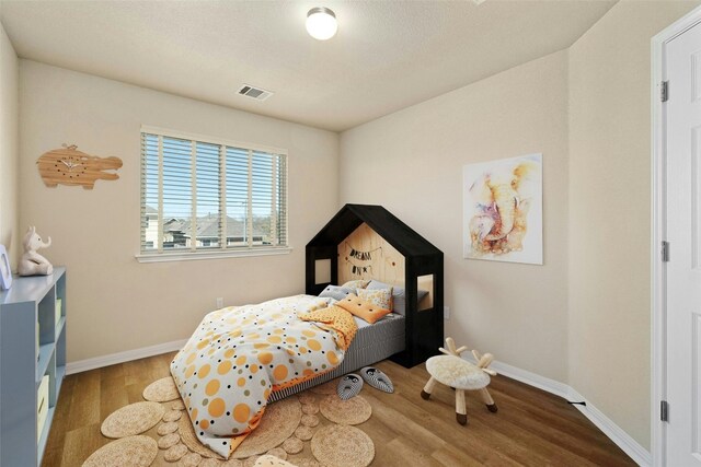 bedroom featuring hardwood / wood-style flooring