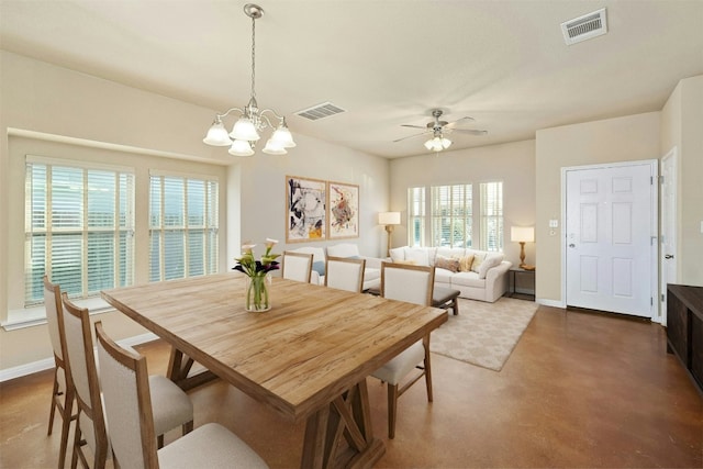 dining area featuring ceiling fan with notable chandelier