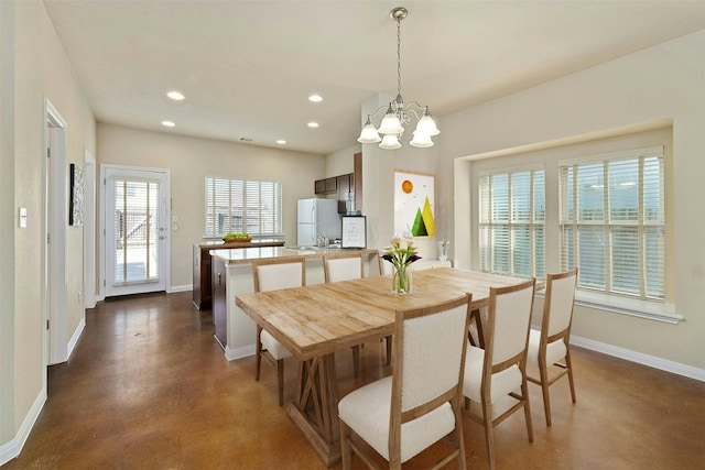 dining space with an inviting chandelier