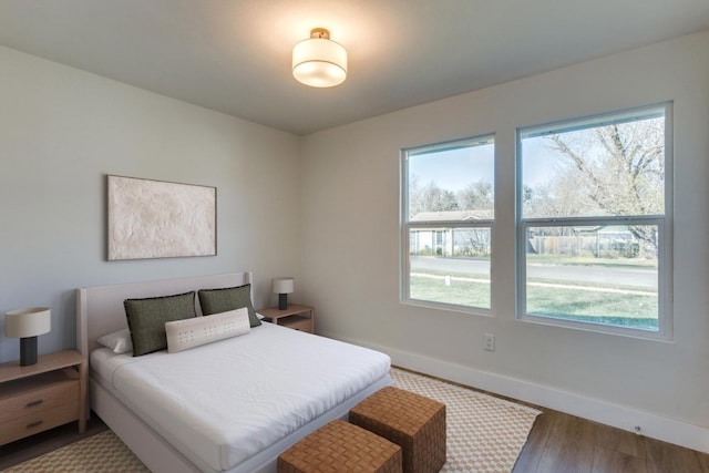 bedroom featuring hardwood / wood-style floors and multiple windows