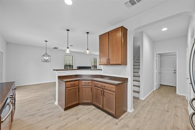 kitchen with kitchen peninsula, decorative light fixtures, light hardwood / wood-style flooring, and dishwasher