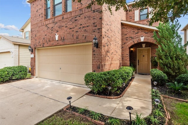 doorway to property with a garage