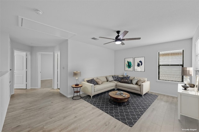 living room featuring light wood-type flooring and ceiling fan