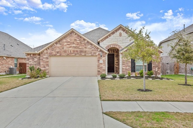 view of front of property with a front yard, central air condition unit, and a garage