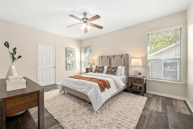 bedroom with dark hardwood / wood-style flooring and ceiling fan