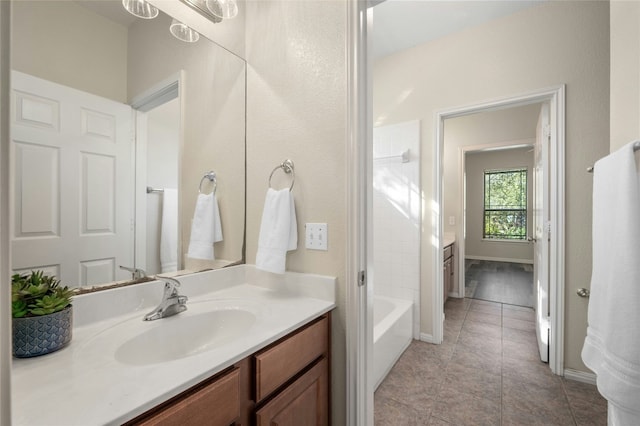 bathroom with tile patterned floors, vanity, and shower / washtub combination