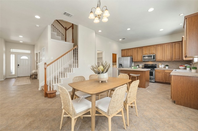 tiled dining area with a notable chandelier and sink