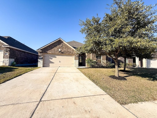 view of front of house with a front yard and a garage