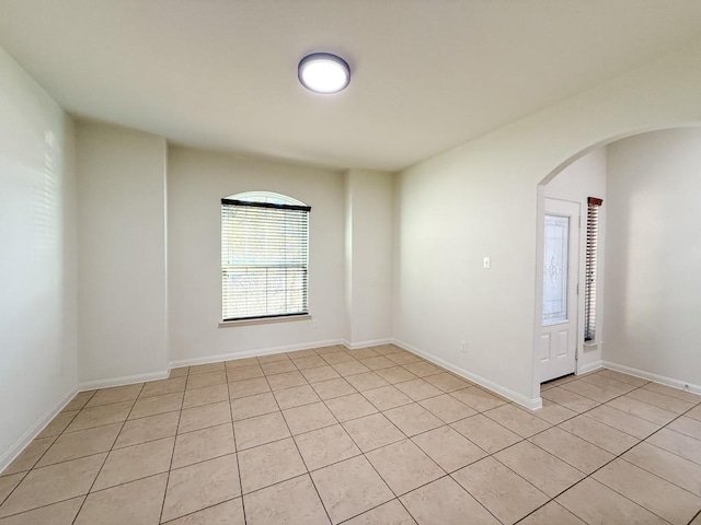 spare room featuring light tile patterned floors