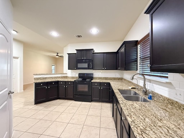 kitchen featuring light stone counters, ceiling fan, sink, black appliances, and light tile patterned floors