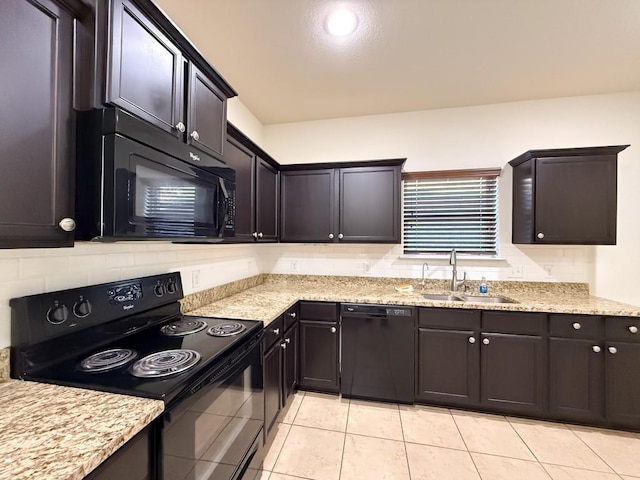 kitchen featuring light tile patterned floors, sink, dark brown cabinetry, and black appliances