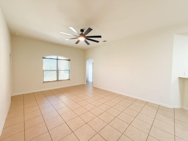 unfurnished room with ceiling fan and light tile patterned flooring