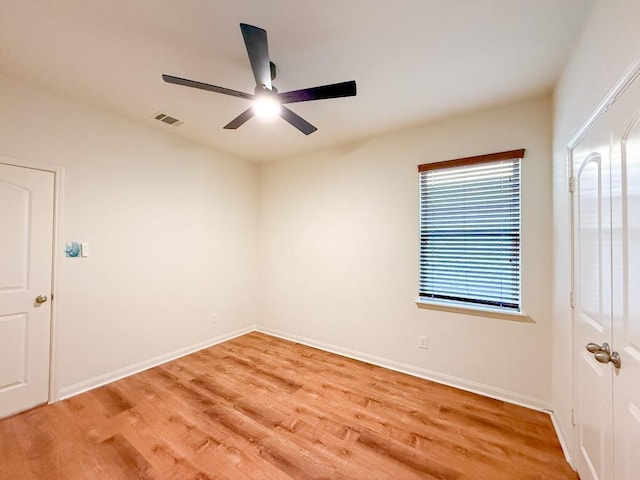 unfurnished room with ceiling fan and light hardwood / wood-style floors