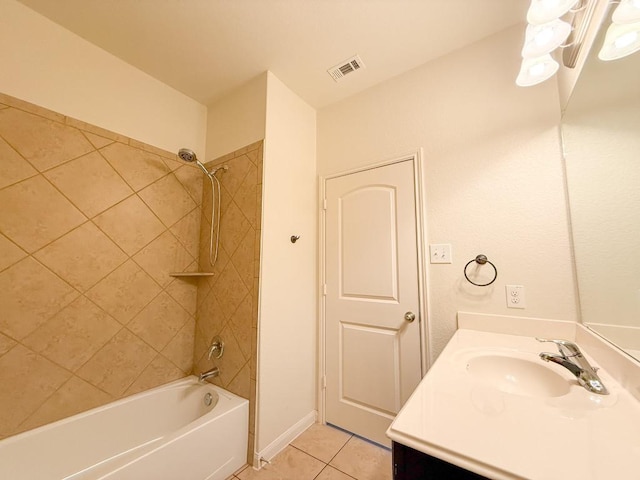 bathroom with tile patterned floors, vanity, and tiled shower / bath combo