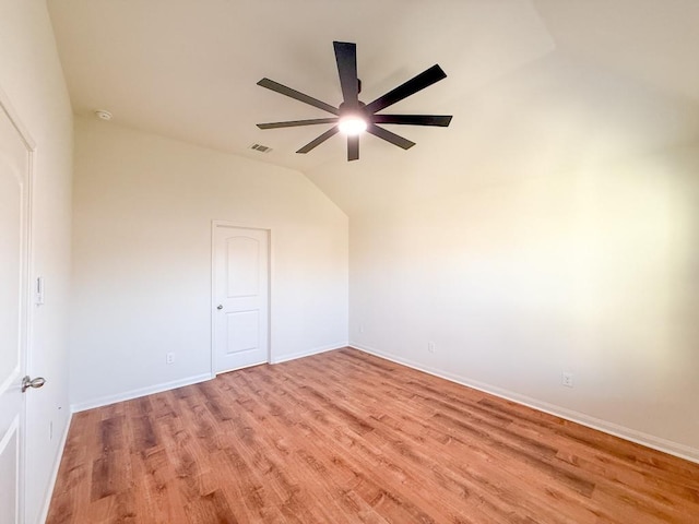 unfurnished room featuring ceiling fan, light hardwood / wood-style floors, and lofted ceiling