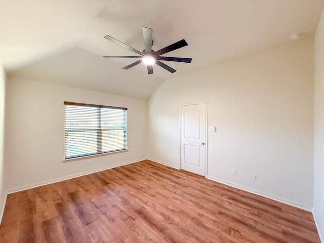 unfurnished room with ceiling fan, lofted ceiling, and light wood-type flooring