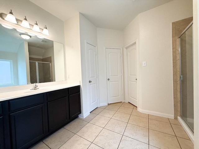 bathroom featuring tile patterned flooring, vanity, and an enclosed shower