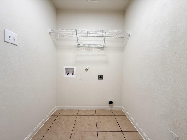 washroom featuring light tile patterned floors, hookup for a washing machine, gas dryer hookup, and electric dryer hookup