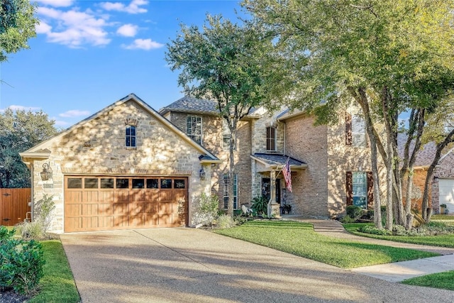 view of front of house featuring a garage and a front lawn