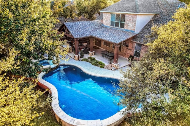 view of swimming pool featuring outdoor lounge area, a patio area, and an in ground hot tub