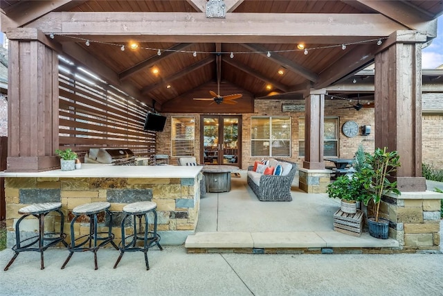 view of patio featuring a bar, ceiling fan, and a grill