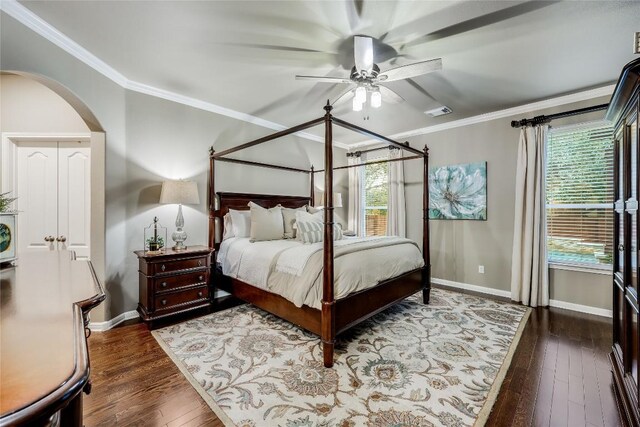 bedroom with ceiling fan, crown molding, and dark wood-type flooring