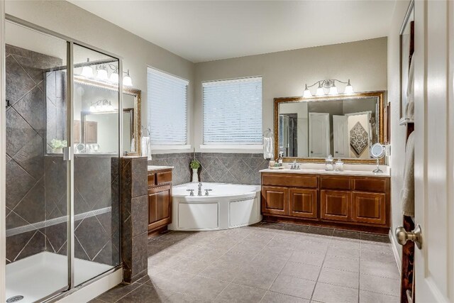 bathroom featuring separate shower and tub, tile patterned flooring, vanity, and tile walls