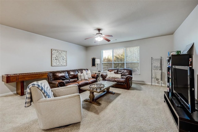 carpeted living room with ceiling fan