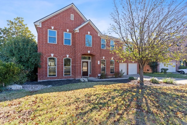 view of front facade with a front yard and a garage