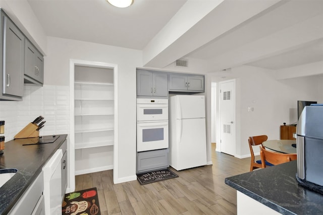 kitchen featuring light wood-type flooring, white appliances, and gray cabinets