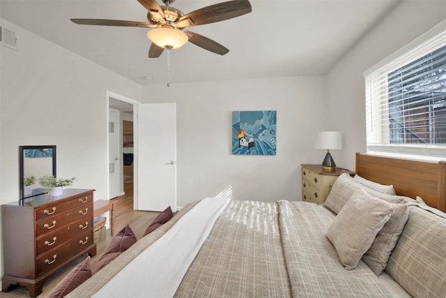 bedroom with light hardwood / wood-style flooring and ceiling fan