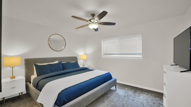 bedroom with ceiling fan and dark hardwood / wood-style floors