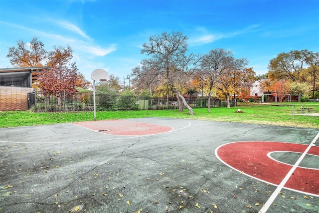 view of sport court featuring a yard