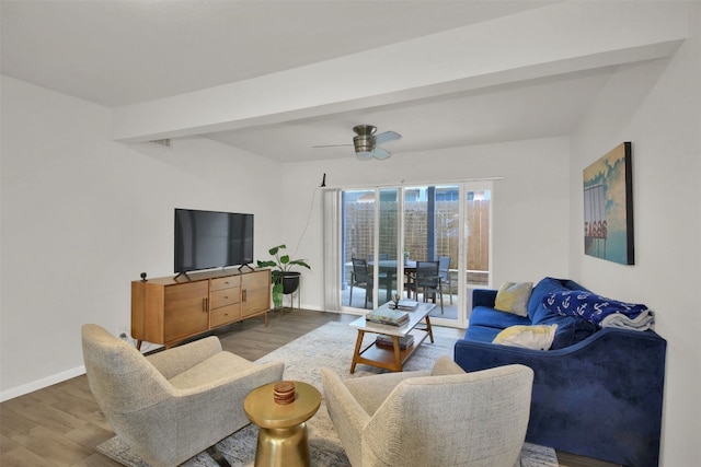 living room featuring beam ceiling, hardwood / wood-style flooring, and ceiling fan