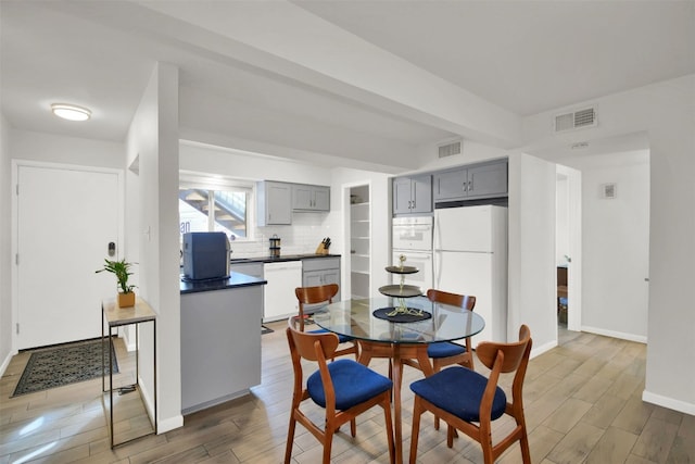 dining area featuring beamed ceiling