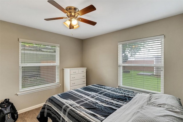 bedroom with ceiling fan and hardwood / wood-style flooring