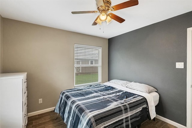 bedroom with ceiling fan and dark wood-type flooring