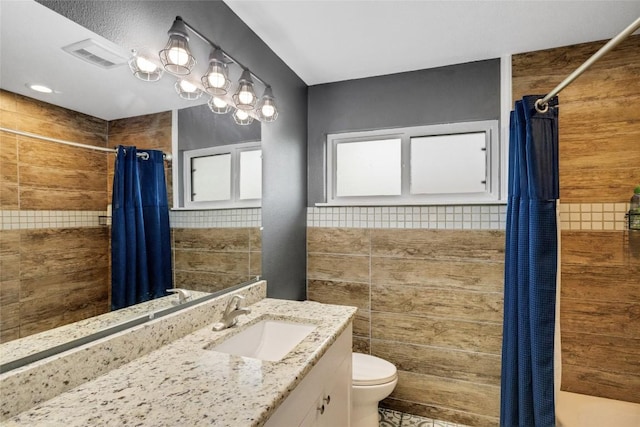 bathroom featuring a shower with curtain, toilet, and vanity