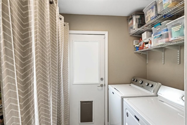 clothes washing area featuring separate washer and dryer