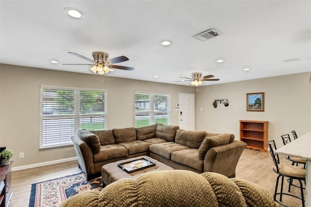 living room with ceiling fan and light wood-type flooring